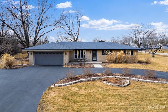 ranch-style house with aphalt driveway, an attached garage, brick siding, and a front yard