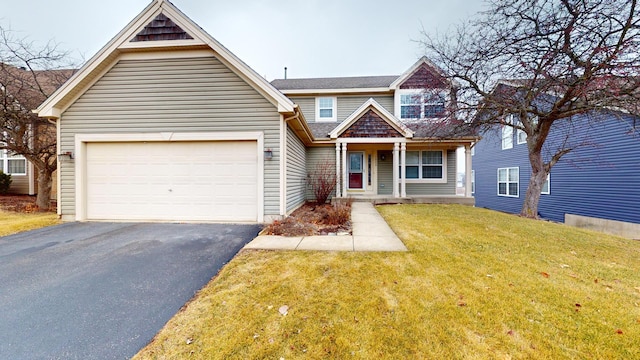 view of front of property with a garage and a front lawn