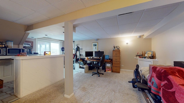 carpeted office space featuring a drop ceiling