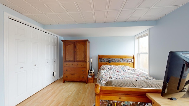 bedroom with a closet and light hardwood / wood-style flooring