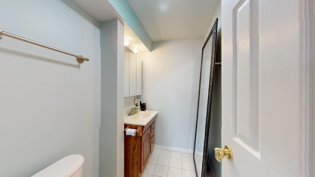 bathroom featuring tile patterned flooring, vanity, and toilet