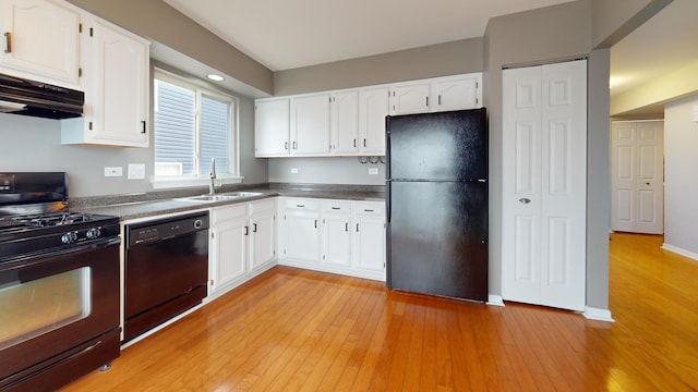 kitchen with sink, light hardwood / wood-style flooring, black appliances, and white cabinets