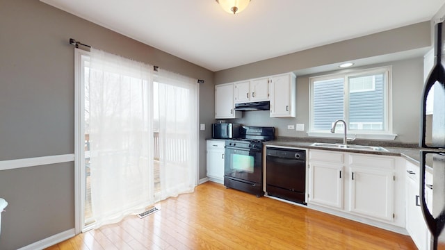 kitchen featuring white cabinetry, sink, light hardwood / wood-style floors, and black appliances