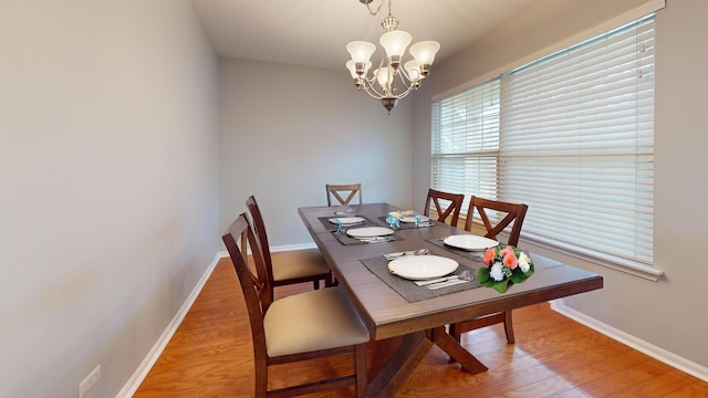 dining room with an inviting chandelier and wood-type flooring