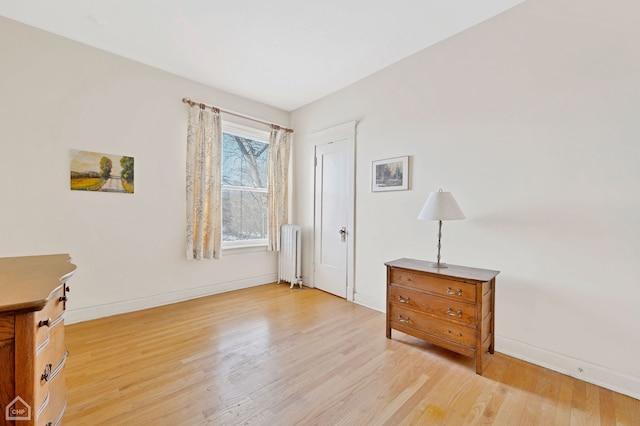 interior space featuring radiator and light hardwood / wood-style floors