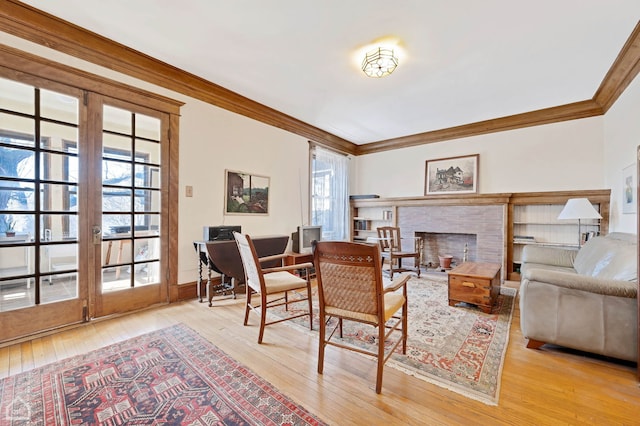 living room featuring ornamental molding and light wood-type flooring