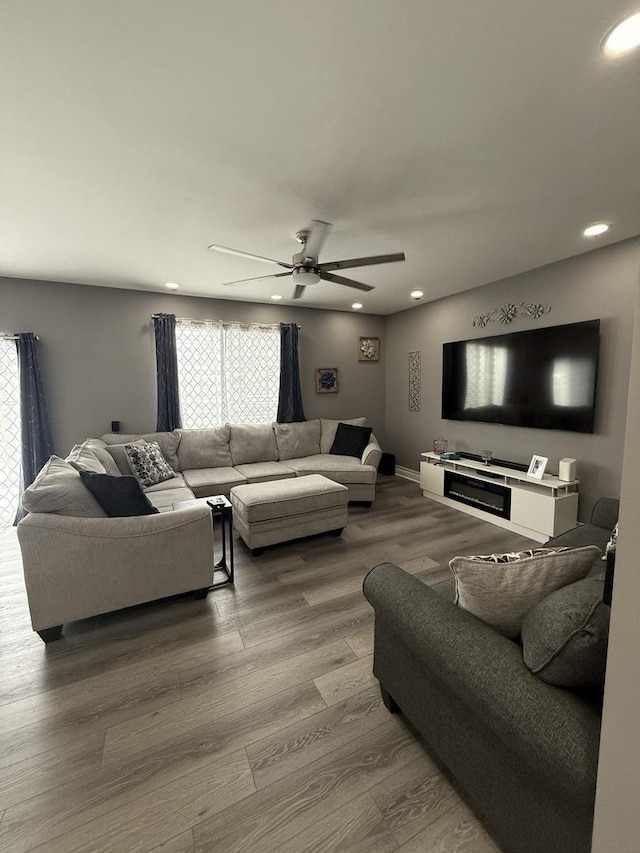 living room featuring hardwood / wood-style flooring and ceiling fan