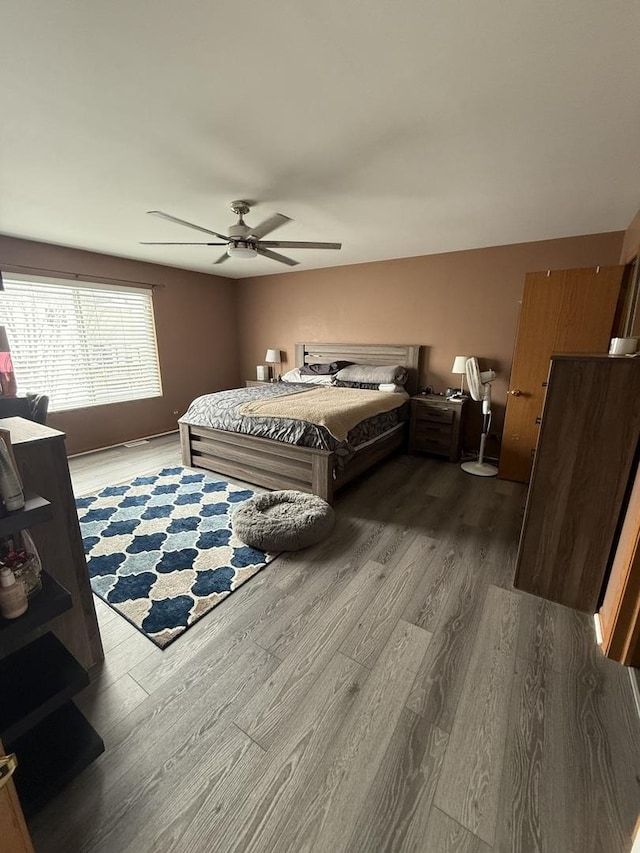 bedroom with wood-type flooring and ceiling fan