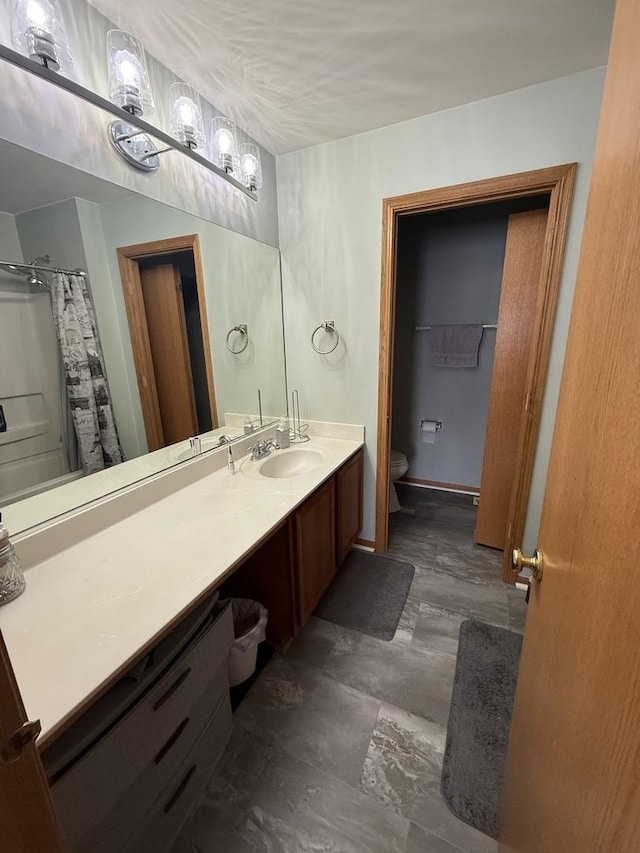 bathroom featuring vanity and toilet