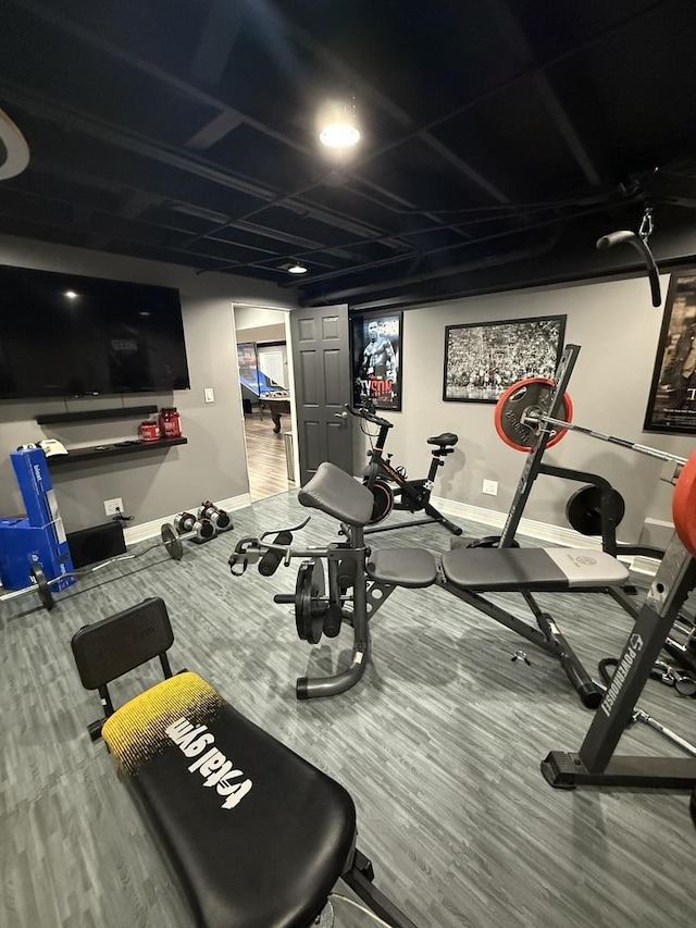 exercise room with hardwood / wood-style floors