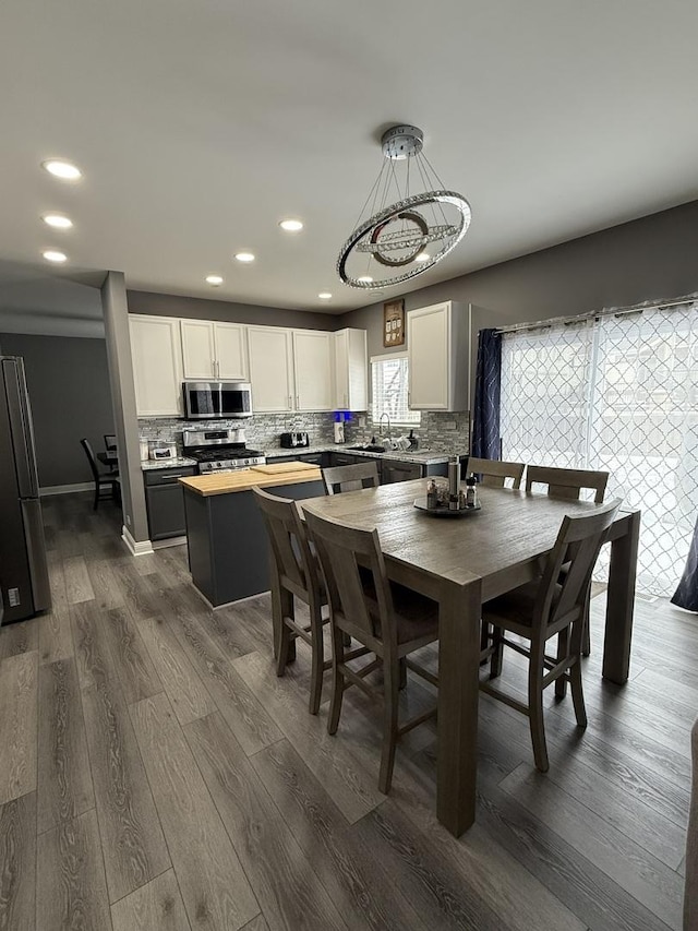 dining space featuring sink and dark hardwood / wood-style flooring