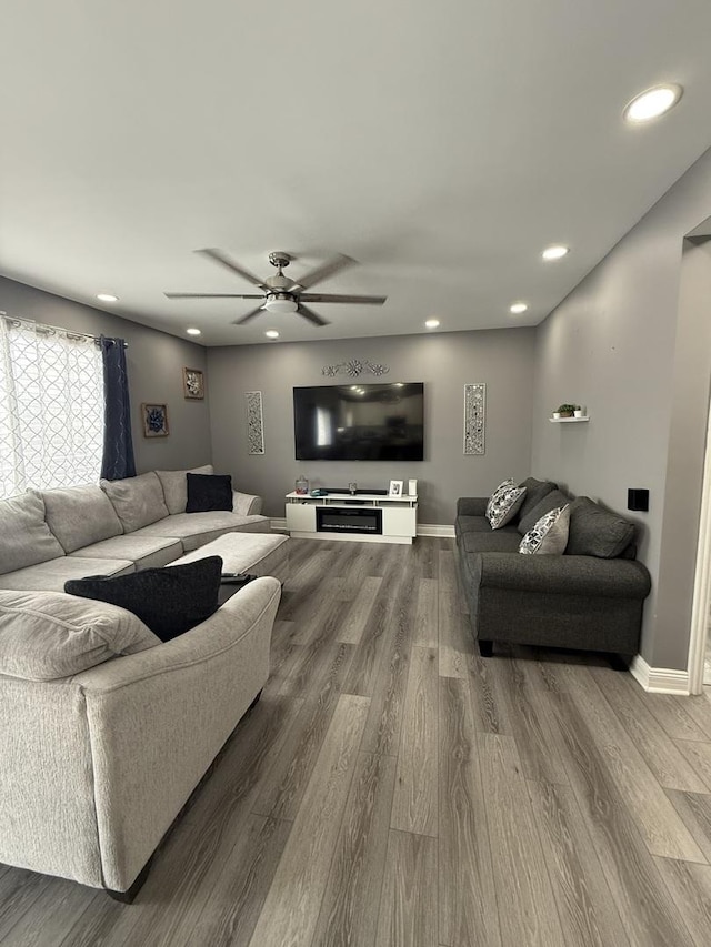 living room with hardwood / wood-style flooring and ceiling fan