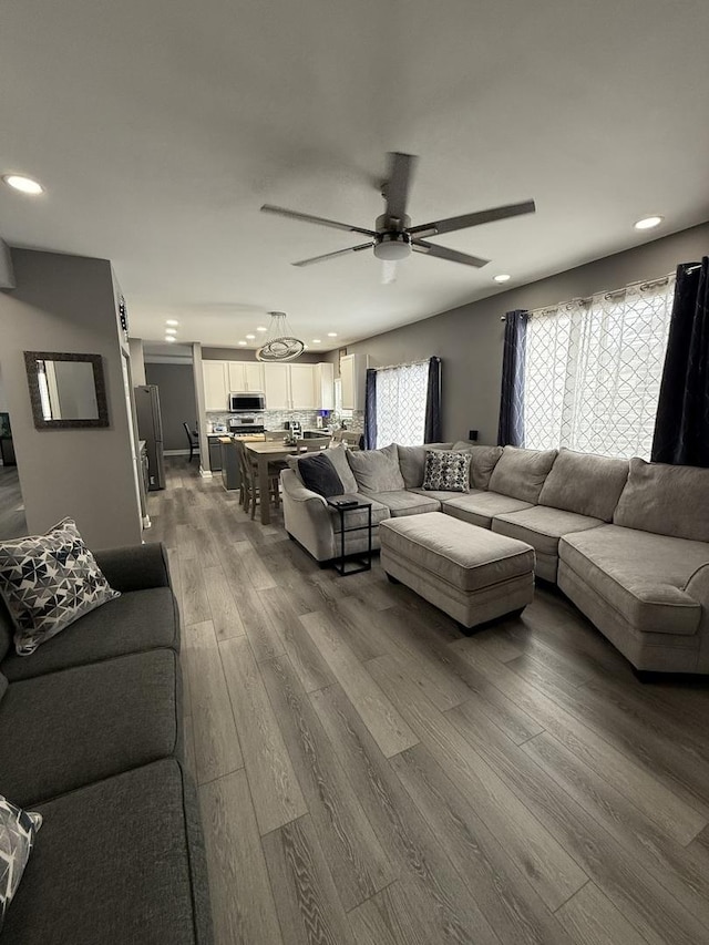 living room with hardwood / wood-style flooring and ceiling fan