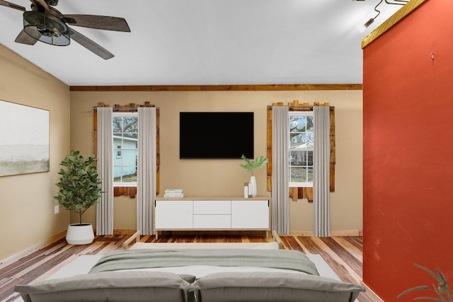 living room with ceiling fan and light wood-type flooring