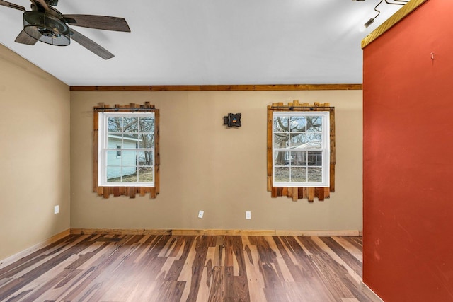 unfurnished room with hardwood / wood-style floors and ceiling fan