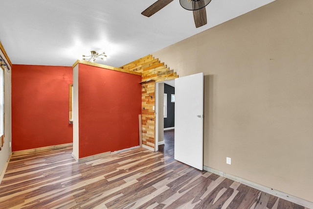 spare room featuring wood-type flooring and ceiling fan