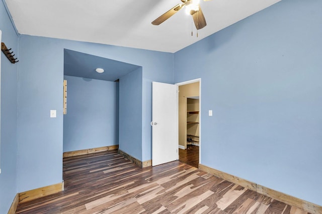 unfurnished bedroom with dark wood-type flooring and ceiling fan