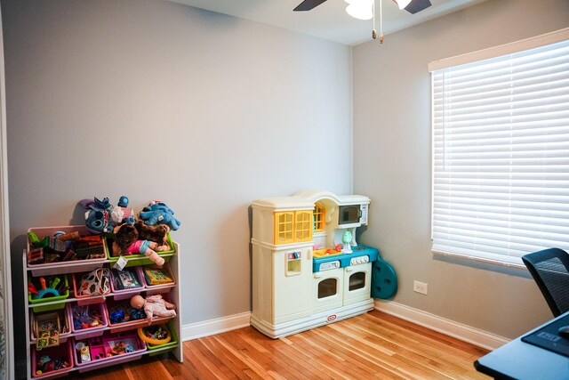 game room featuring a ceiling fan, baseboards, and wood finished floors