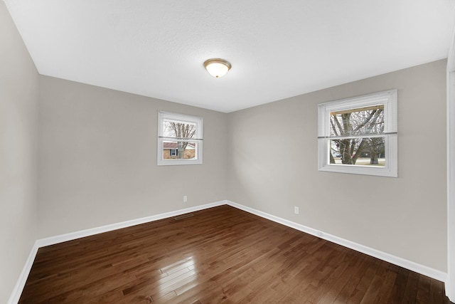 spare room featuring hardwood / wood-style floors