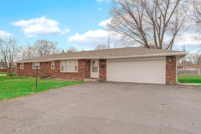 ranch-style home with a garage and a front lawn