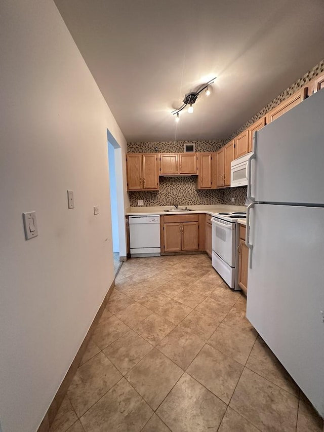 kitchen featuring white appliances, tasteful backsplash, light tile patterned floors, and light countertops