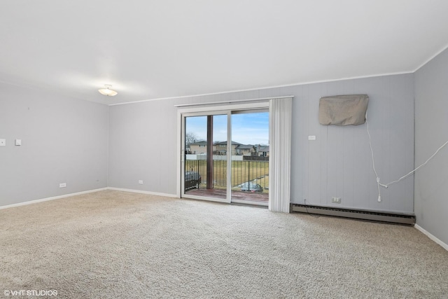 carpeted empty room featuring ornamental molding and a baseboard heating unit