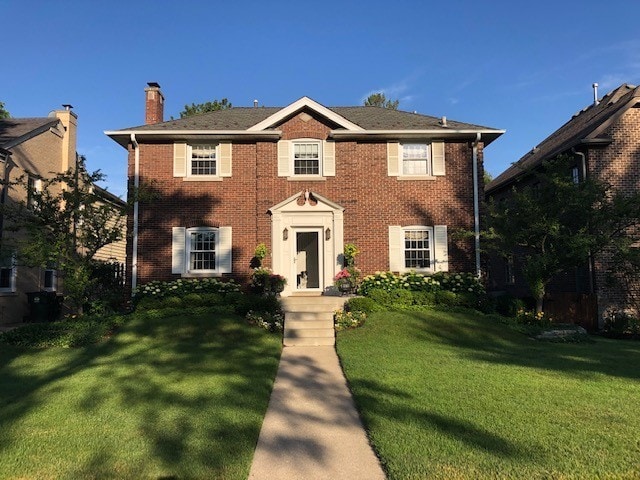 colonial inspired home with a front yard