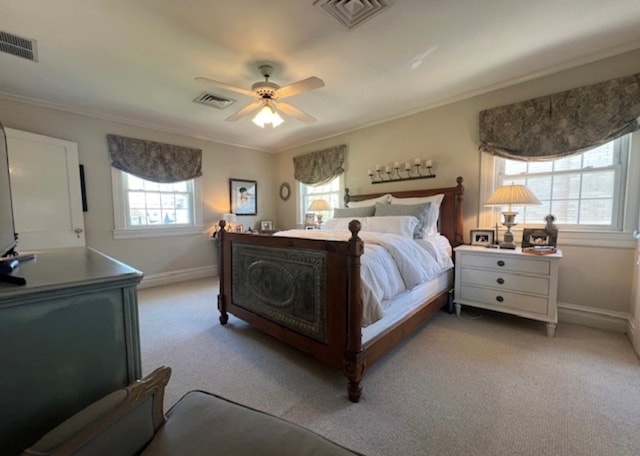 bedroom featuring crown molding, ceiling fan, and light carpet