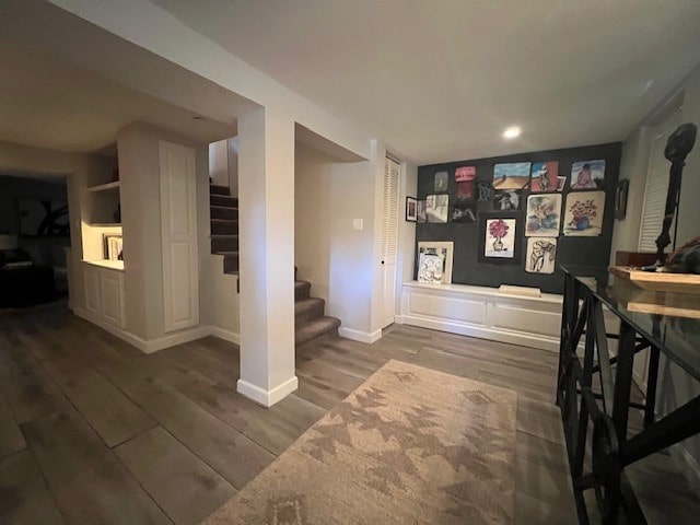 corridor with dark hardwood / wood-style flooring