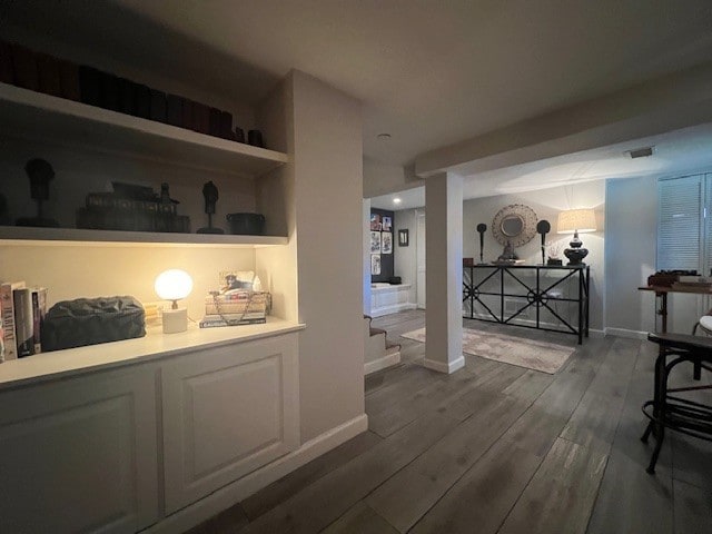 bar featuring white cabinetry and hardwood / wood-style floors