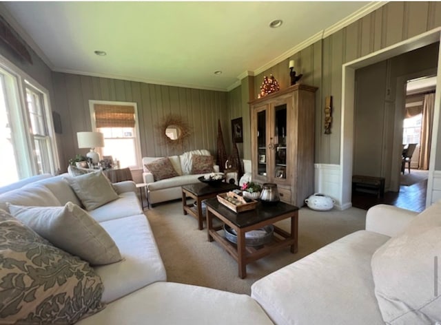 carpeted living room featuring crown molding