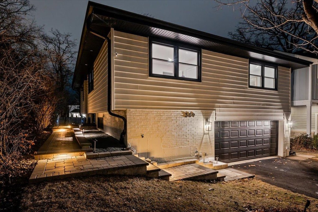 back of property with a garage