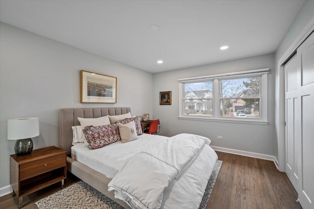 bedroom with dark wood-type flooring and a closet