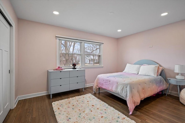 bedroom featuring dark hardwood / wood-style floors and a closet