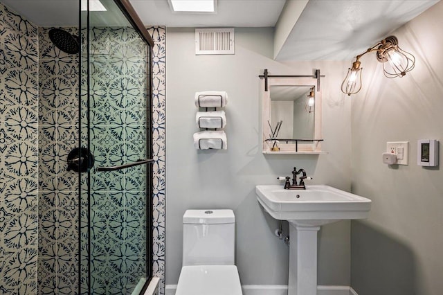 bathroom featuring sink, toilet, and walk in shower