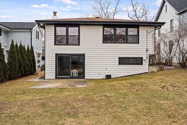 rear view of house featuring a patio and a lawn