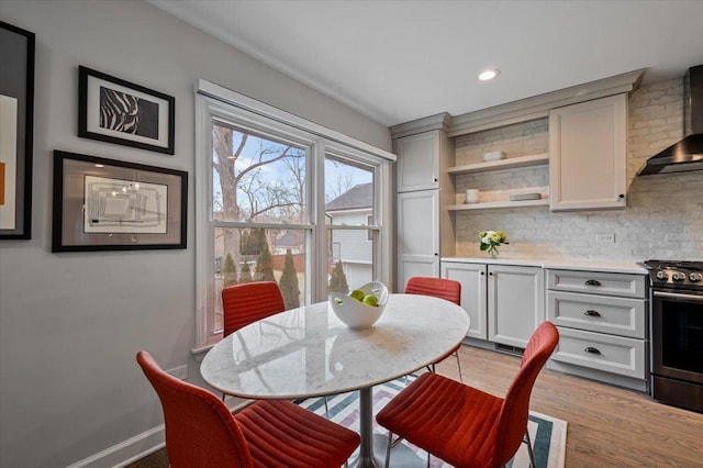 dining space with light hardwood / wood-style floors