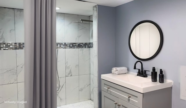 bathroom featuring vanity and a tile shower