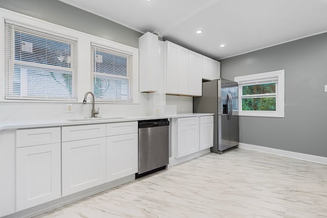 kitchen with sink, stainless steel appliances, and white cabinets