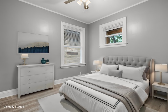 bedroom with crown molding, ceiling fan, and light hardwood / wood-style flooring