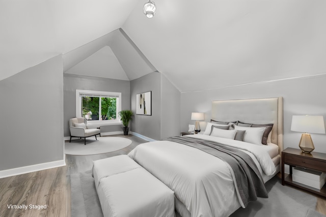 bedroom with hardwood / wood-style floors and vaulted ceiling