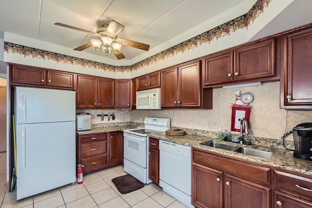 kitchen featuring sink, light stone counters, light tile patterned floors, white appliances, and decorative backsplash