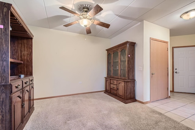 carpeted spare room with ceiling fan