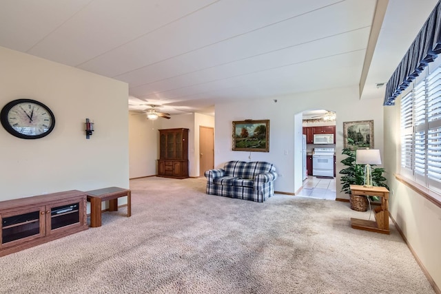 carpeted living room with ceiling fan