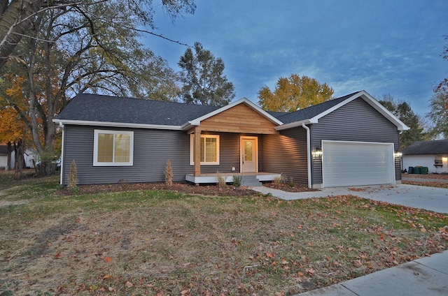 ranch-style house featuring a garage, a front yard, and covered porch