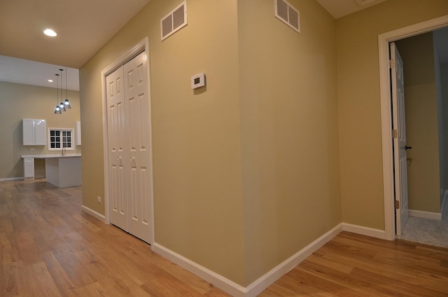 hall with light hardwood / wood-style flooring