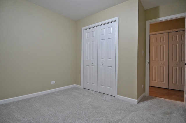 unfurnished bedroom with a closet and light carpet