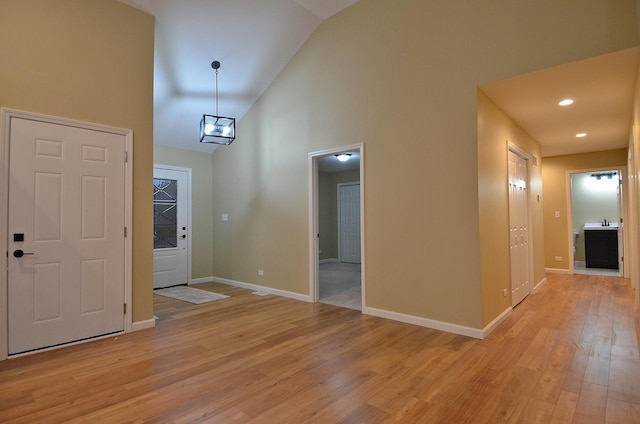 interior space featuring high vaulted ceiling and light hardwood / wood-style flooring