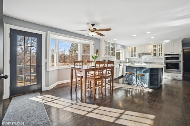 dining area featuring dark hardwood / wood-style floors and ceiling fan