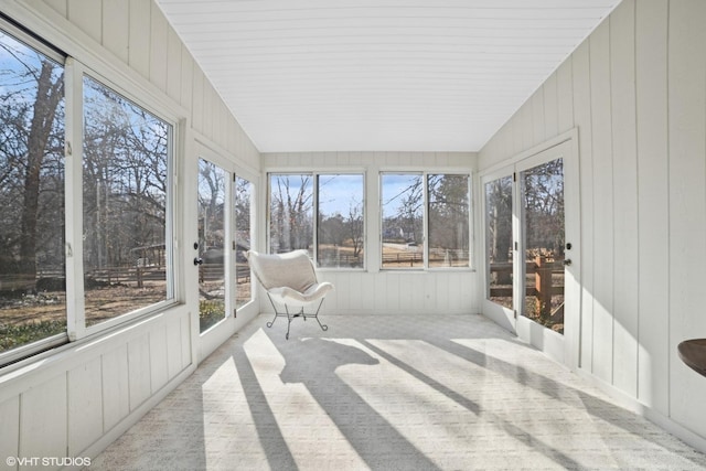 unfurnished sunroom featuring lofted ceiling